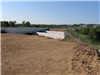 Completed soil embankment at Bypass 4 bridge over railroad awaits the construction of bridge abutments