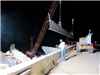 A crane hoists the first steel beam into place for the new bridge