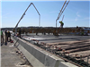 Crews pour concrete for the bridge deck