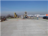 Crews stand on the finished bridge deck to pour the forward approach slab