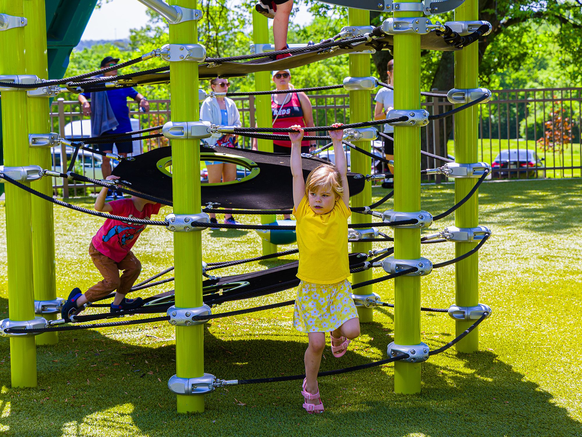 Girl climbing on new rope play structure