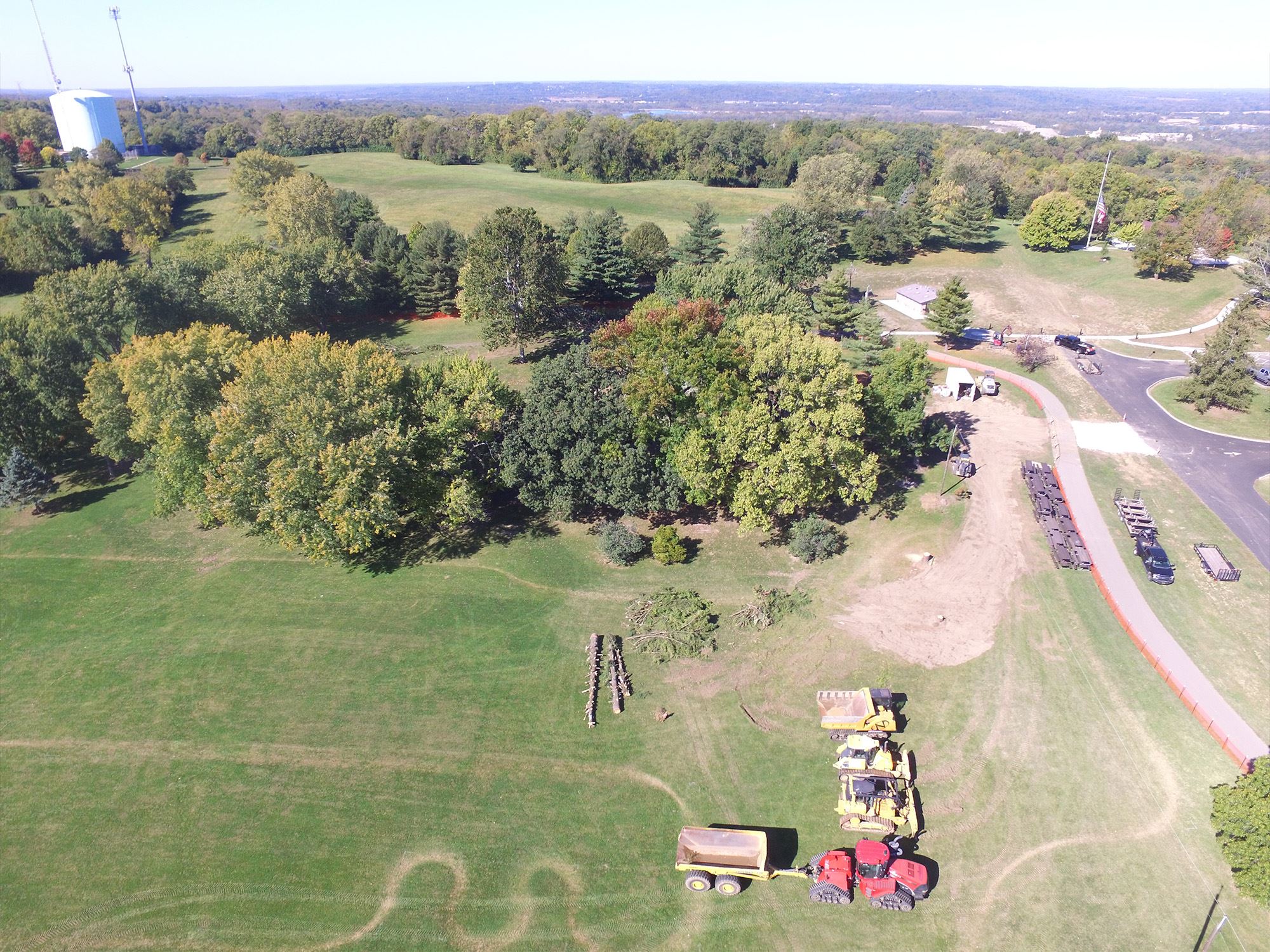 Park field cleared with construction vehicles staged for work