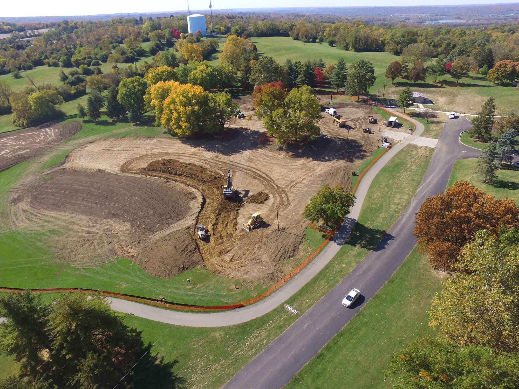 Excavators digging land during early park construction