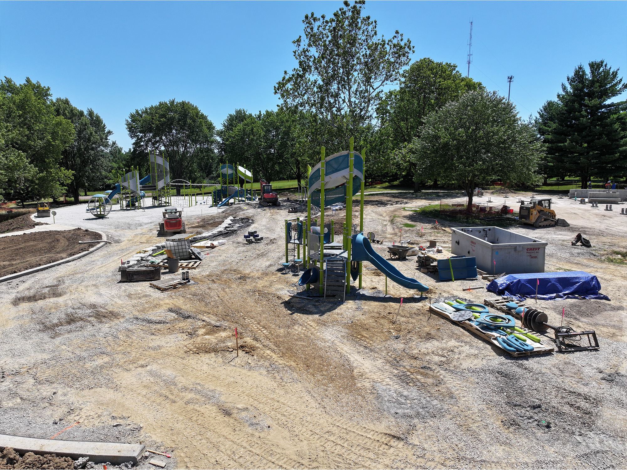 Playground equipment partially assembled on gravel base